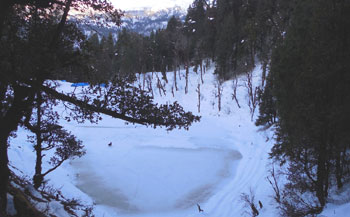 Juda ka talaab campsite on the kedarkantha trek is first stopover. Lake is covered with snow in November.